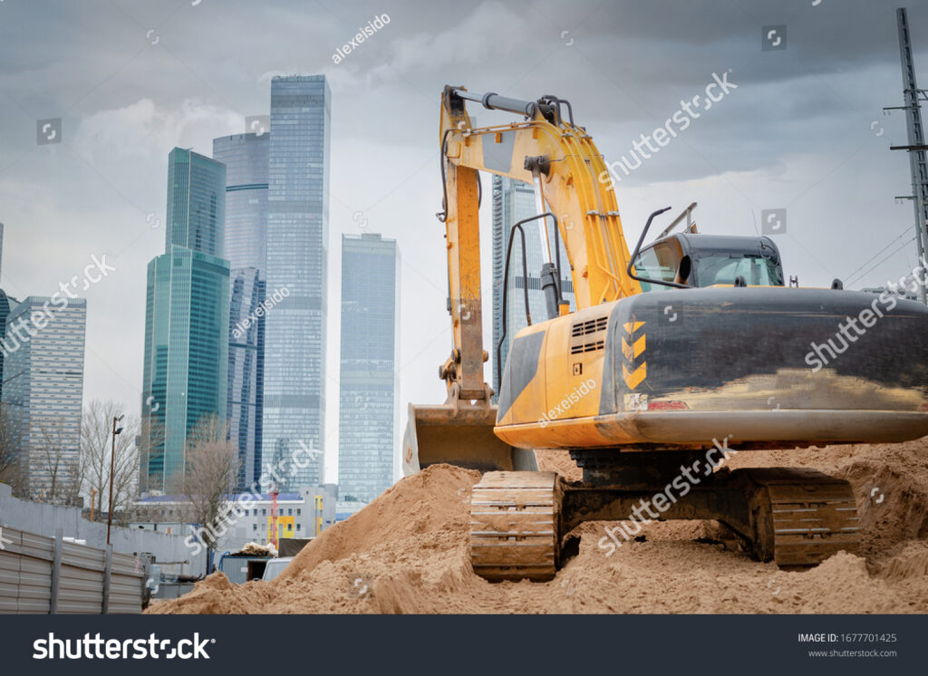 stock-photo-construction-machinery-and-excavator-on-the-background-of-skyscrapers-concept-of-building-1677701425