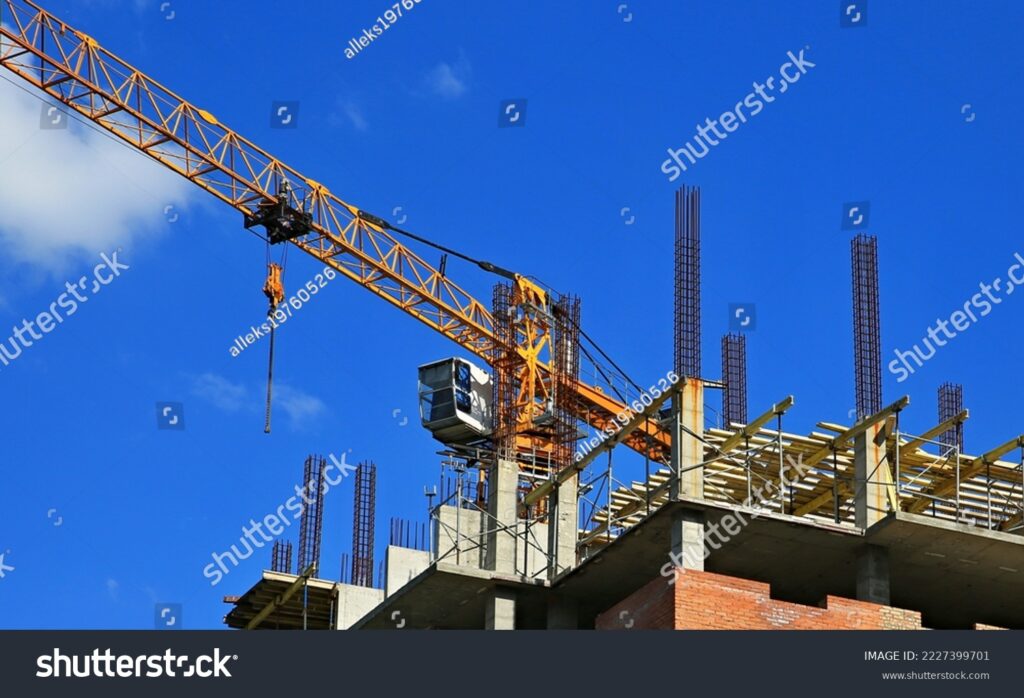 stock-photo-lifting-crane-under-construction-real-estate-2227399701