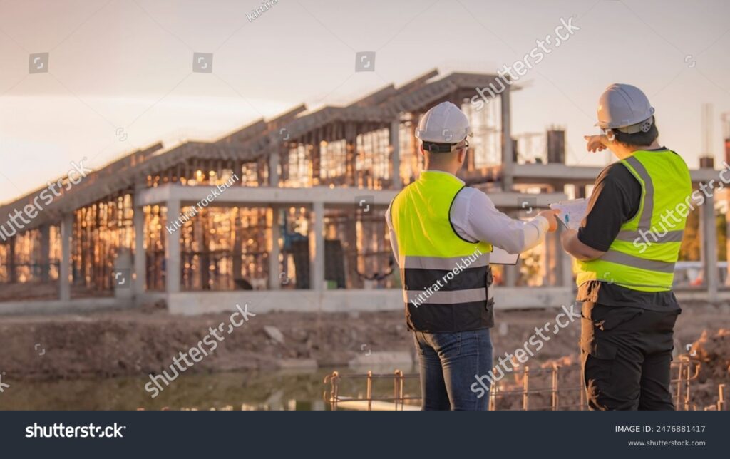 stock-photo-two-asian-engineer-working-at-site-of-a-large-building-project-thailand-people-work-overtime-at-2476881417