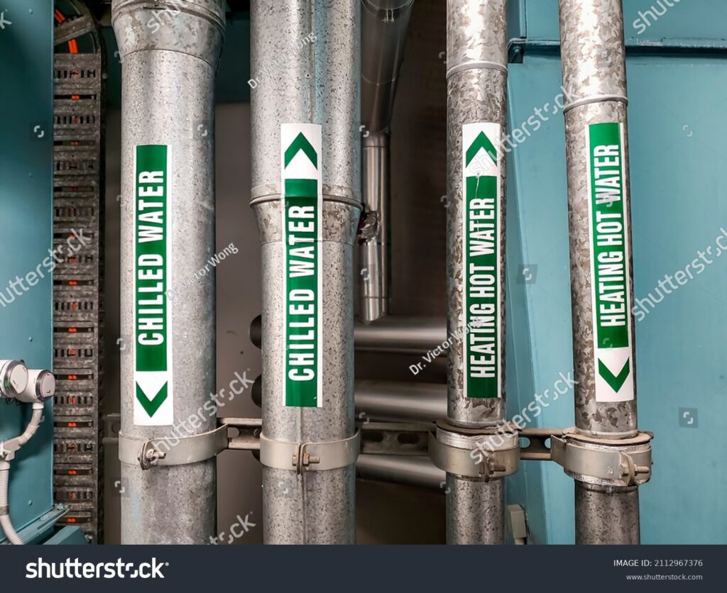 stock-photo-vertical-pipes-carrying-chilled-water-and-heating-hot-water-that-are-clearly-labeled-for-safety-and-2112967376